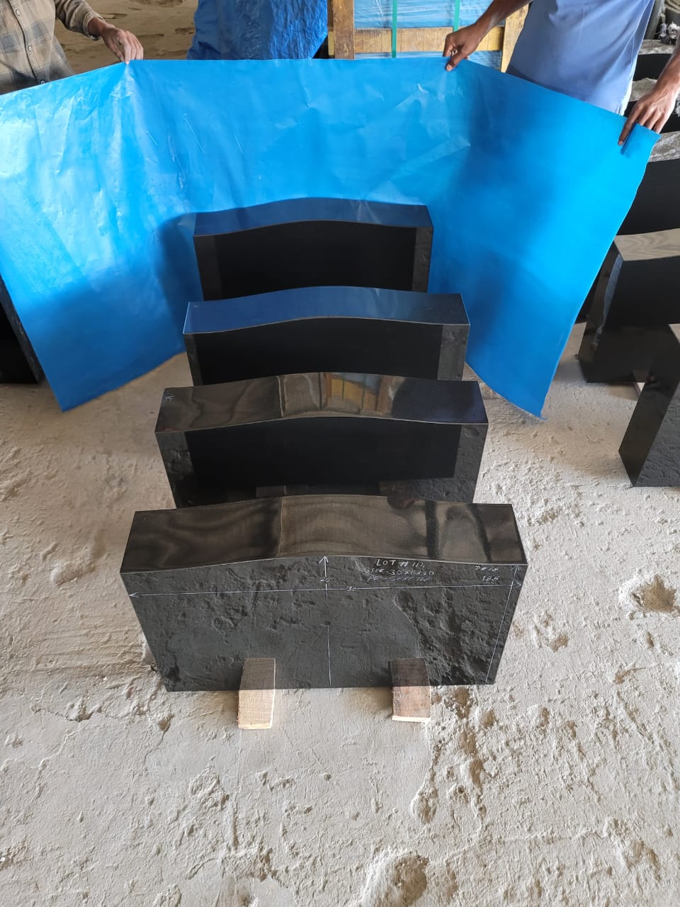 Team Inspecting Black Granite Pieces